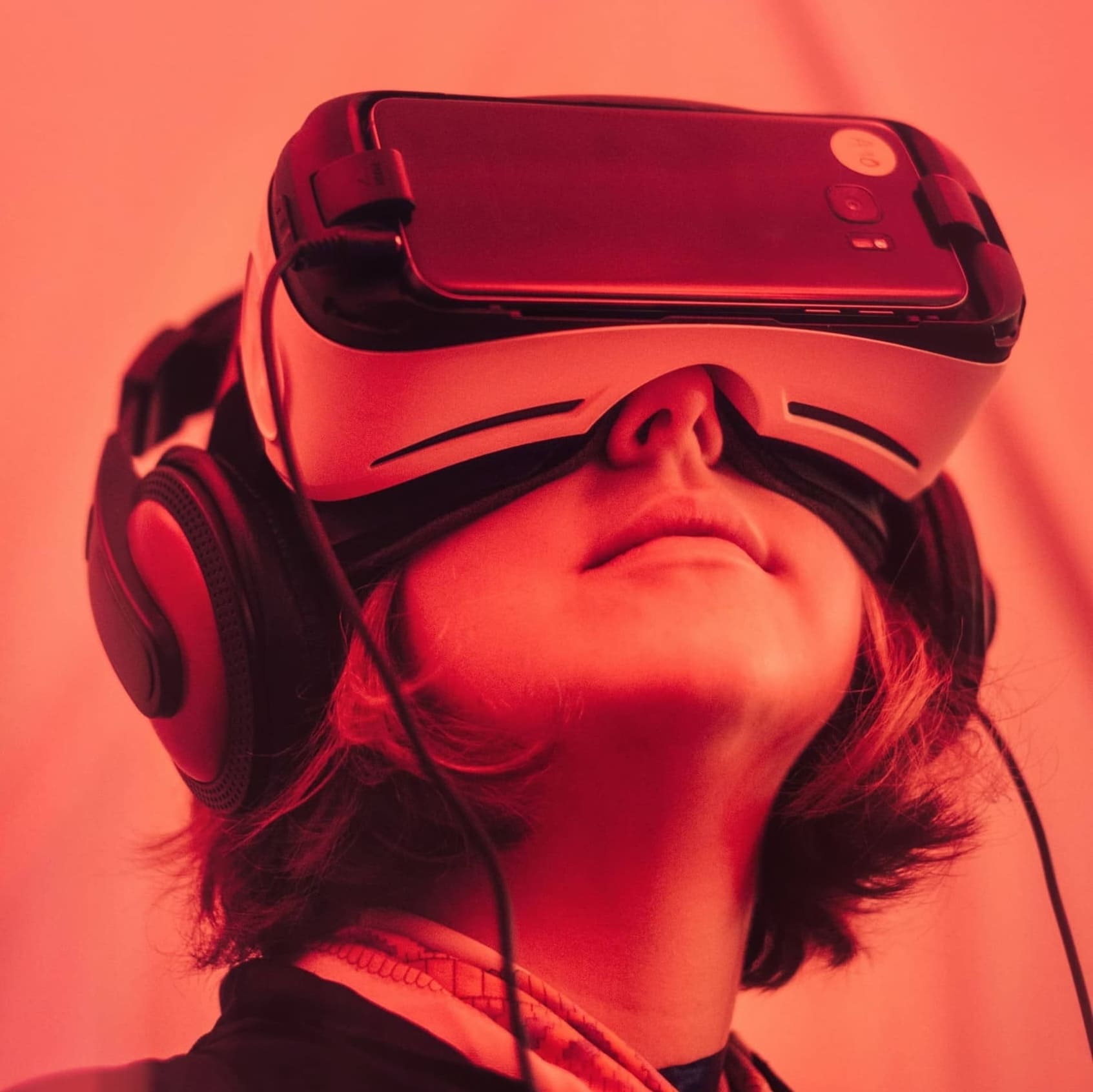 A person with VR glasses and headphones