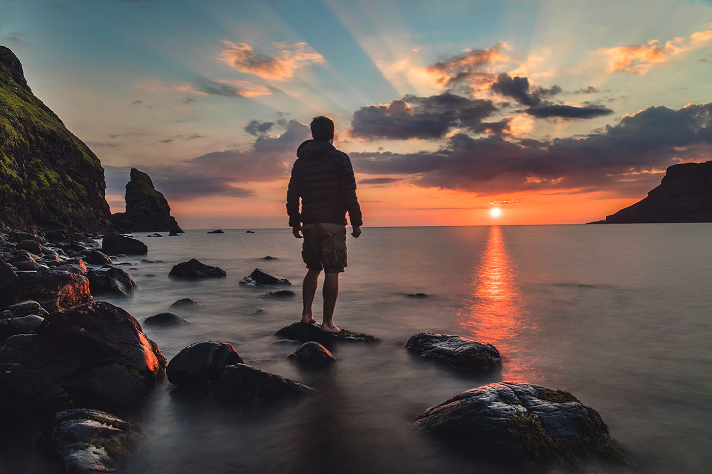 man by water during sunset